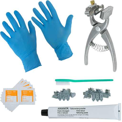 A tattoo kit including blue nitrile gloves, a tube of 5oz black paste, a set of letters and numbers, aluminum pliers, an applicator brush, and a cleaning tool.