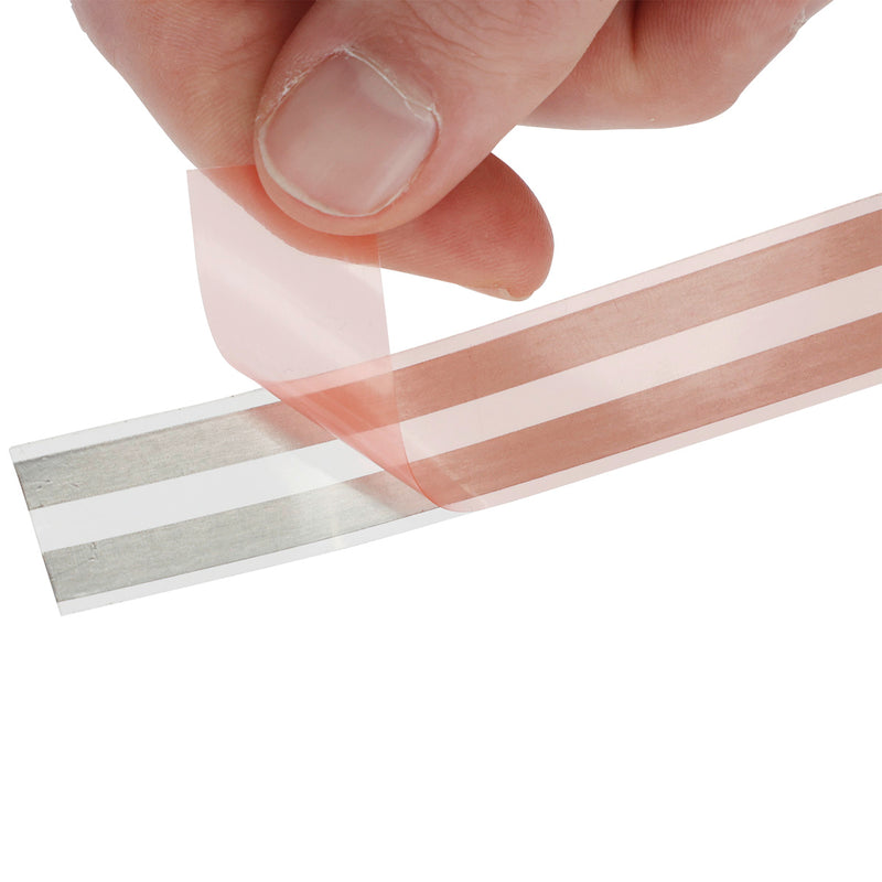 Close-up of a person peeling the protective backing off the Kerbl Snail Stop self-adhesive copper tape for slug and snail protection.